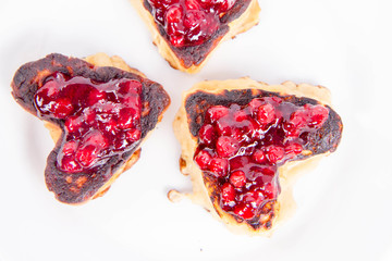 Heart shaped pancakes with cowberry jam