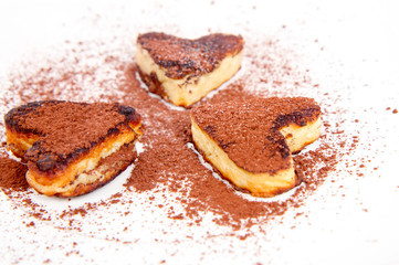 Heart shaped pancakes covered with cocoa