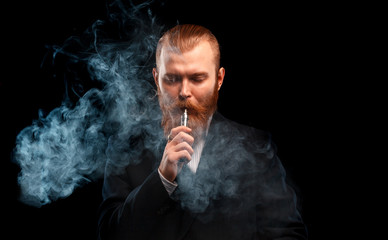 vaping man holding a mod. A cloud of vapor. Black background