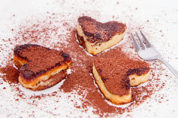 Heart shaped pancakes covered with cocoa