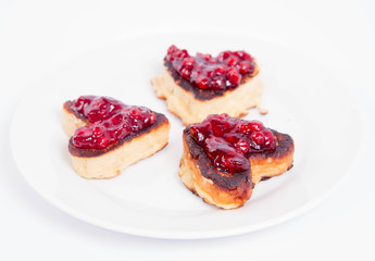 Heart shaped pancakes with cowberry jam