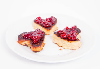 Heart shaped pancakes with cowberry jam