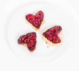 Heart shaped pancakes with cowberry jam