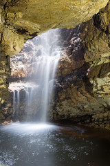 Fototapeta na wymiar Waterfall in a cave near Durness, Scotland. 