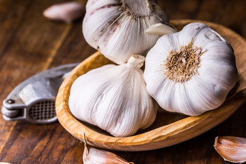 Garlic. Garlic Cloves and Garlic Bulb in vintage wooden bowl.