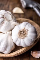 Garlic. Garlic Cloves and Garlic Bulb in vintage wooden bowl.
