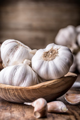 Garlic. Garlic Cloves and Garlic Bulb in vintage wooden bowl.