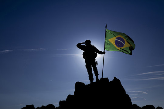Soldier on top of the mountain with the Brazilian flag