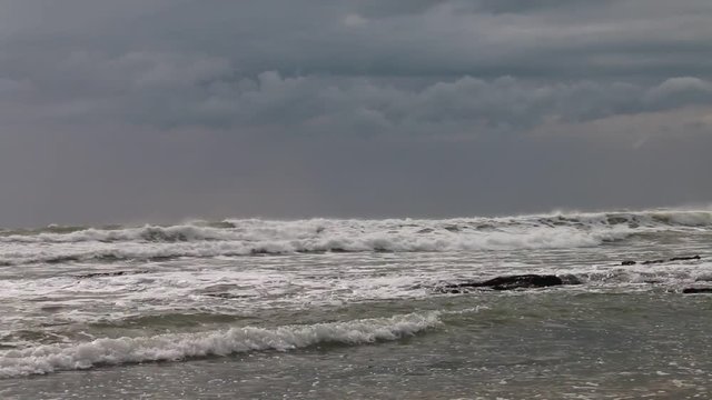 The raging sea in a stormy day next to the lighthouse of Trafalgar, in the beach of Los Ca&ntilde;os de Meca, Spain