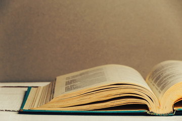 Open book,  hardback book on wooden table. Back to school. Copy space. 