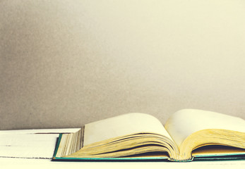 Open old book on wooden table. Copy space for text. Clean pages.
