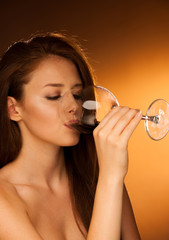 woman drinks glass of red wine