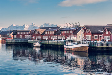 Fototapeta na wymiar Typical red harbor houses in Svolvaer at early morning. Svolvaer is located in Nordland County on the island of Austvagoya.