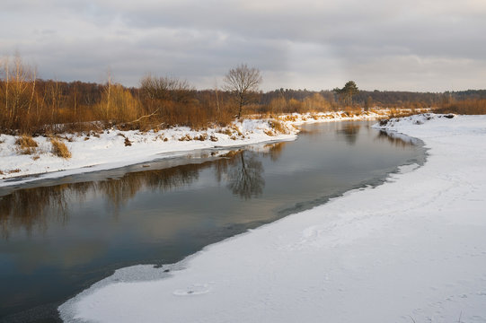 non-freezing river on winter forest backgrounds