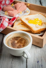     Idea for the celebration of Valentine's day: breakfast - toast with scrambled eggs in the form of hearts, sausages and cheese in the form of hearts and aromatic coffee with cinnamon, copy space