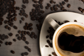 Cup of coffee on the beans background