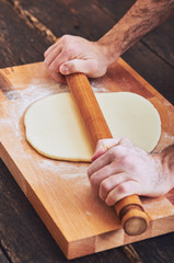 Making handmade pasta with wooden rolling pin