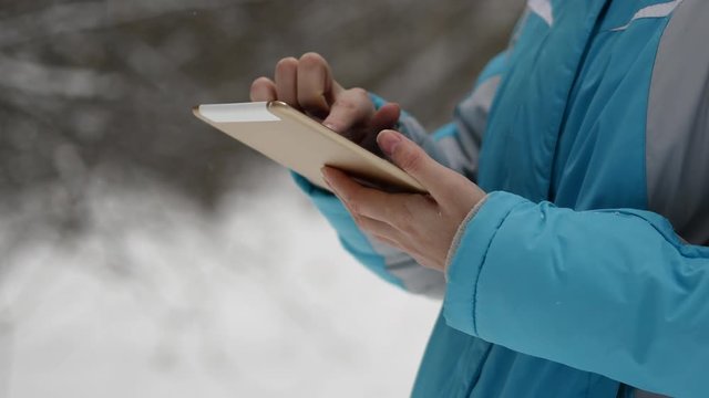 Woman Search On The Map In Tablet. Winter Forest, Snowy Weather Day