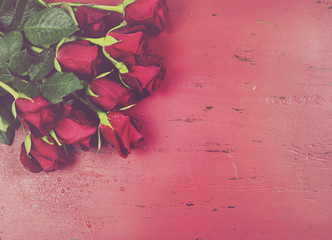 Valentine roses on red wood background