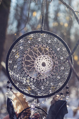 Dreamcatcher made of feathers, leather, beads, and ropes