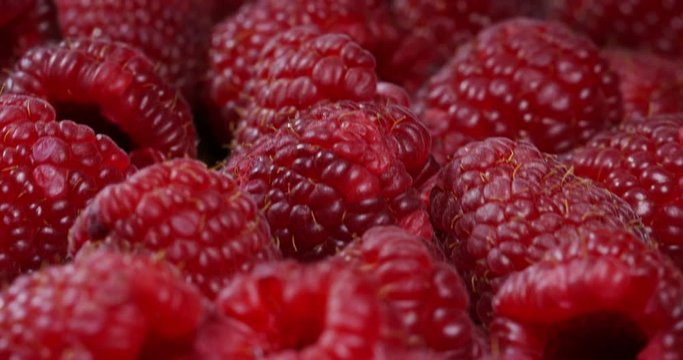 Extreme macro of juicy raspberries and genuine. Fresh red fruits and rich antioxidant vitamins. organic raspberries fruits, concept of vegan and vegetarian.