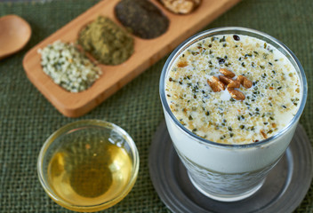 Homemade smoothie made from oats milk, shelled hemp and honey