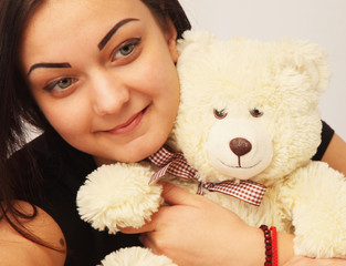 beautiful woman with Bear toy as a symbol of  happy childhood