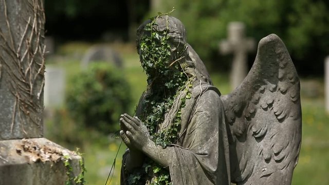 Gothic Angel on a cemetery praying (gravestone)