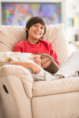 Child inside interior of modern home sitting on sofa
