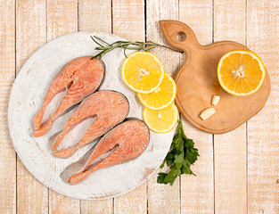 Raw marinated trout fillet on wooden cutting board.