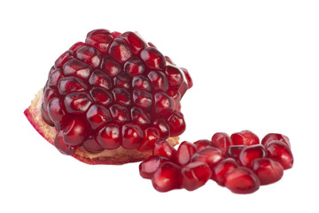 Purified piece of the fruit pomegranate and red seeds isolated on a white background