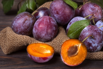 plums on the wooden background with sackcloth