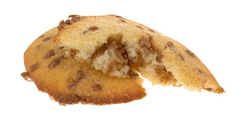 Broken apple spice muffin top on a white background.