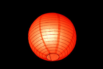 Close-up view of traditional asian red ball lamp lantern isolated on black background