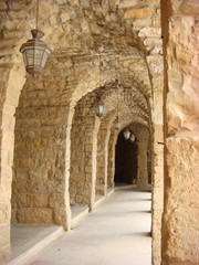 Vaulted aisle with hanging lanterns in Deir Alqamar - Lebanon