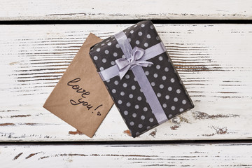 Fototapeta premium Love you card and gift. Black spotted box with bow. Express your feelings more often.