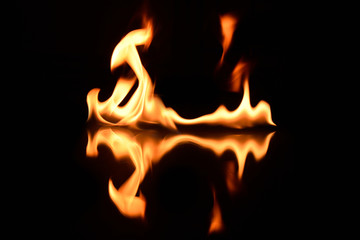 Fototapeta premium flames on a black background with mirror reflection