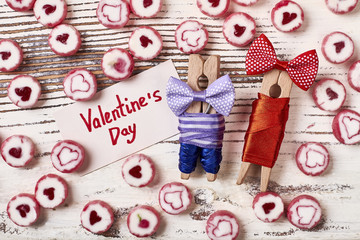 Clothespins and Valentine's Day card. Bow ties and candies. Start day with sweet surprise.
