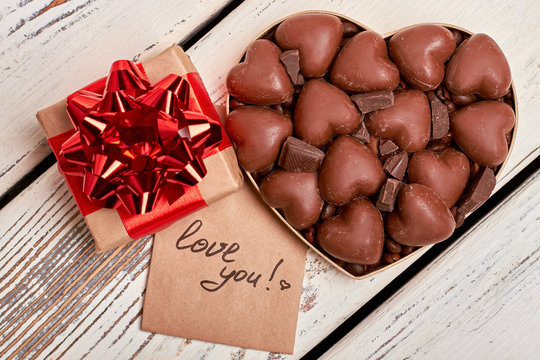 Love you card and chocolates. Gift box, greeting paper, candies. Delicious magic moments.