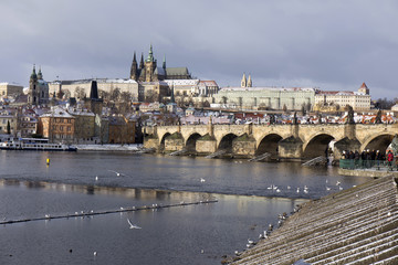 Snowy freeze Prague Lesser Town with gothic Castle and Charles Bridge, Czech republic