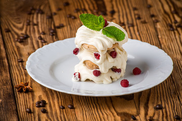 raspberry cake with cream and strawberries on a plate