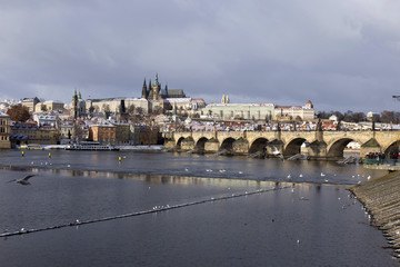 Snowy freeze Prague Lesser Town with gothic Castle and Charles Bridge, Czech republic