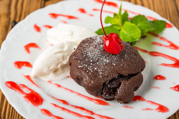 chocolate lava cake set with ice cream and strawberry on white plate