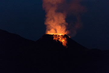 Ile de la reunion island Piton de la fournaise volcano eruption with lava flow and steam at night - 132766801