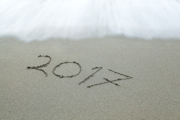 Inscription 2017 on a sandy beach