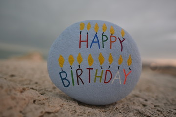 Happy Birthday carved and colored on a stone