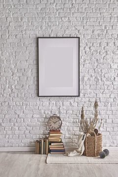 frame and decorative books with brick wall concept
