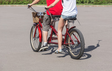 man and woman riding on a tandem bike