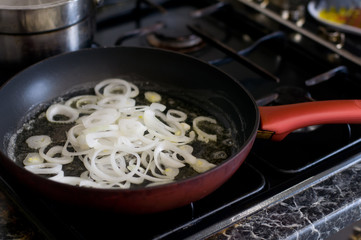 Onion is frying on pan red color