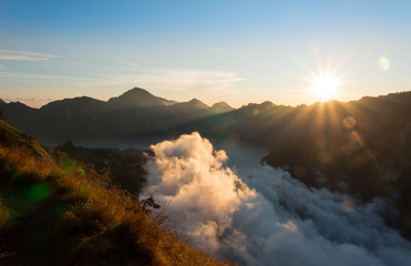 Indonesia Mount Rinjani crater rim sunrise with clouds